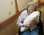 Dorothy Hartley hugs a robotic pet named Paro at the Sunny View Retirement Community in Cupertino, Calif. on Tuesday, July 8, 2014. Paro is a therapeutic device designed for elderly residents of convalescent homes to encourage stimulation and interaction. (Gary Reyes/Bay Area News Group)